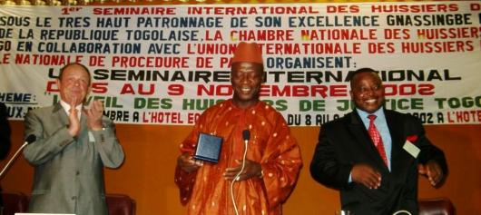 Duafa Ahoomey-Zunu, on the right, with the Ministry for Justice of Togo, at the centre, and the President of UIHJ on the right, during the UIHJ International Seminar of Lomé on 8 November 2002 